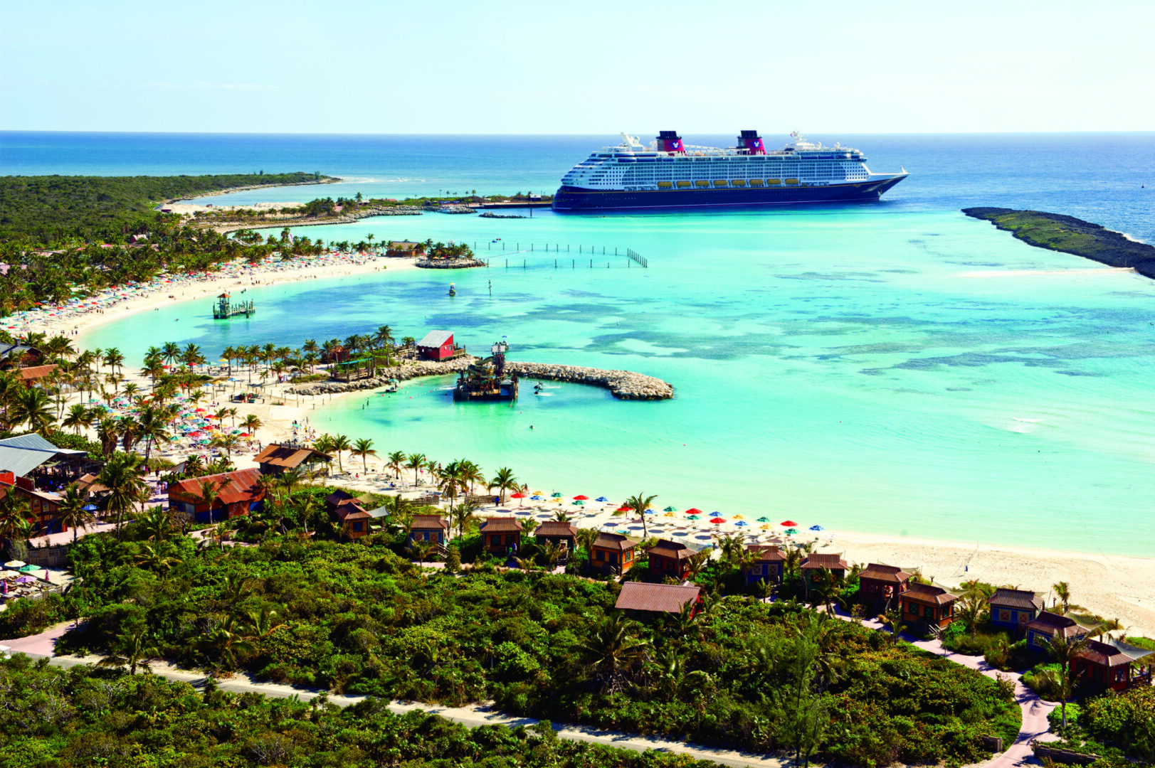 A cruise ship is docked at the beach.