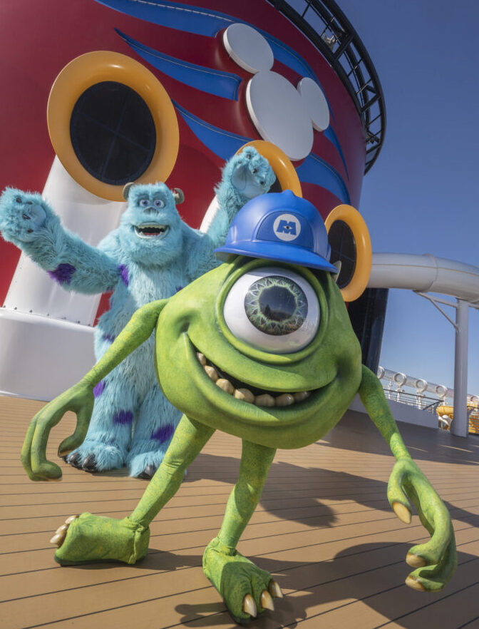 A green monster and blue one on the deck of a cruise ship.