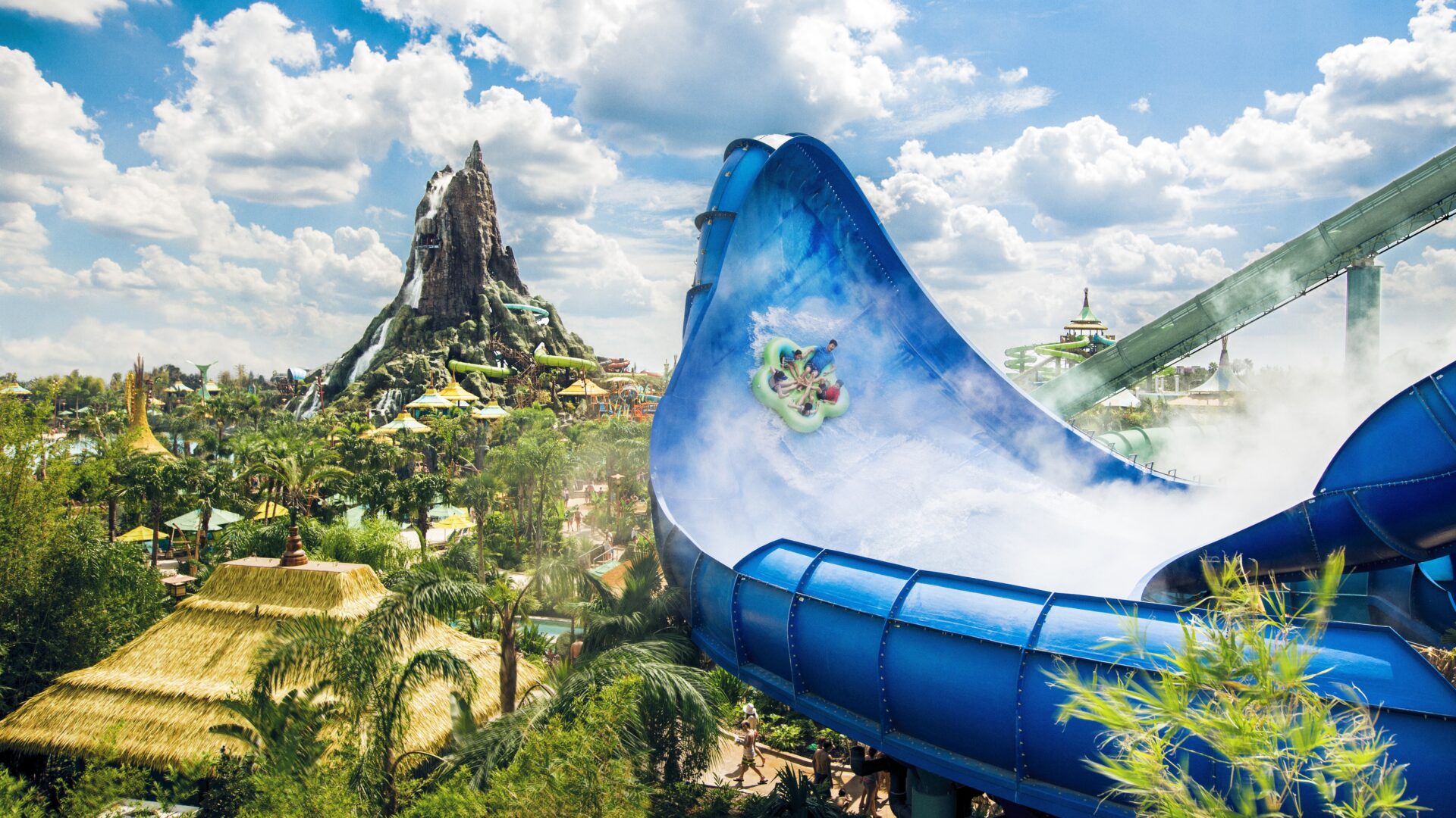 A water slide with a mountain in the background.